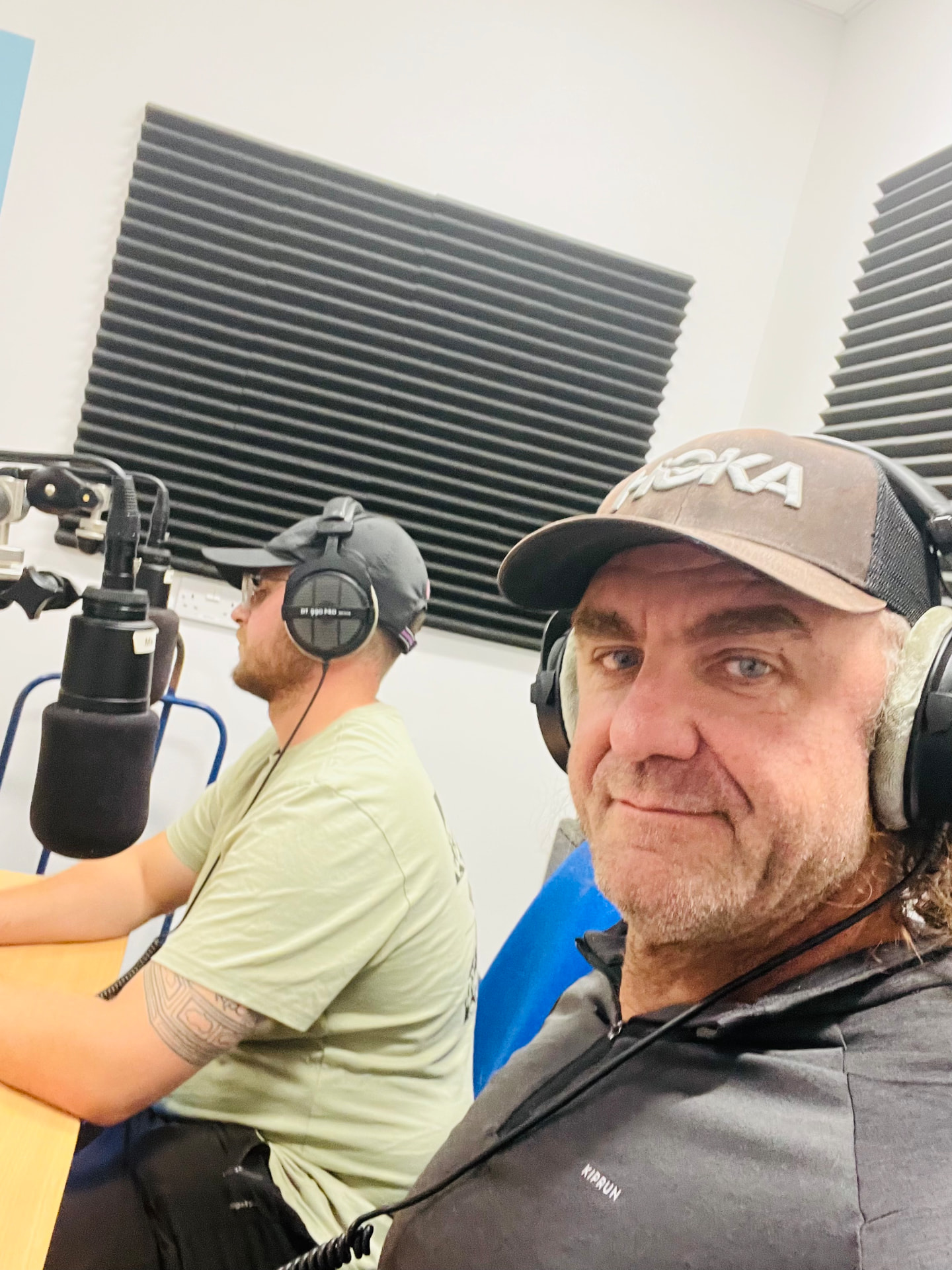 Rob Prior in a radio studio with headphones, recording a talk alongside a host.