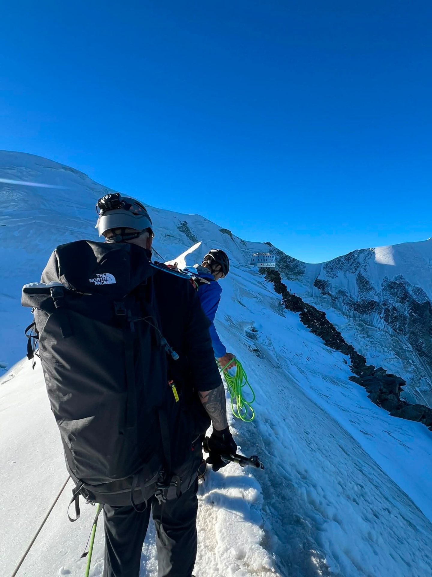 Danny Tolhurst and his guide on a snow slope below the ridge.