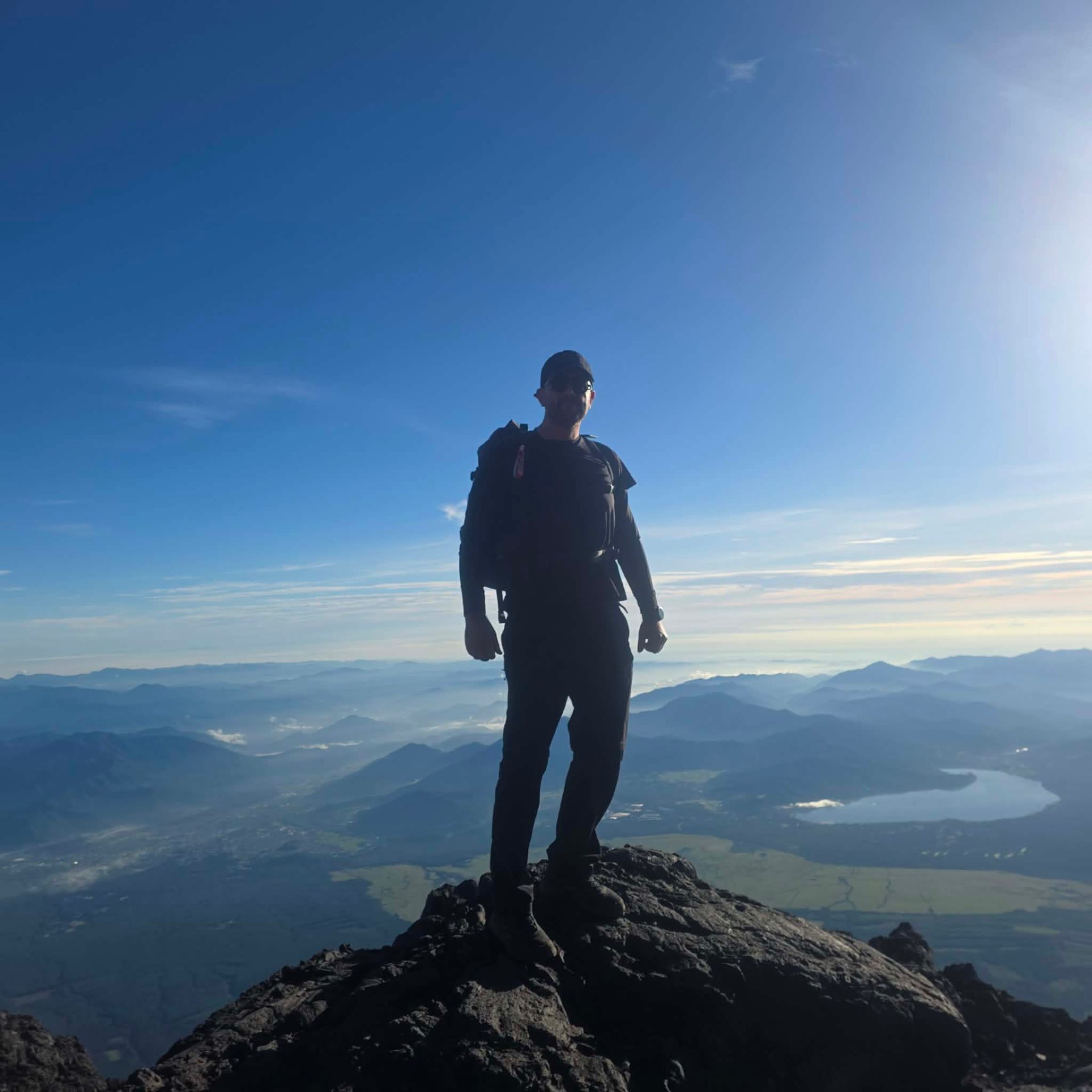 Danny Tolhurst standing on rocky ground above a sea of cloud.