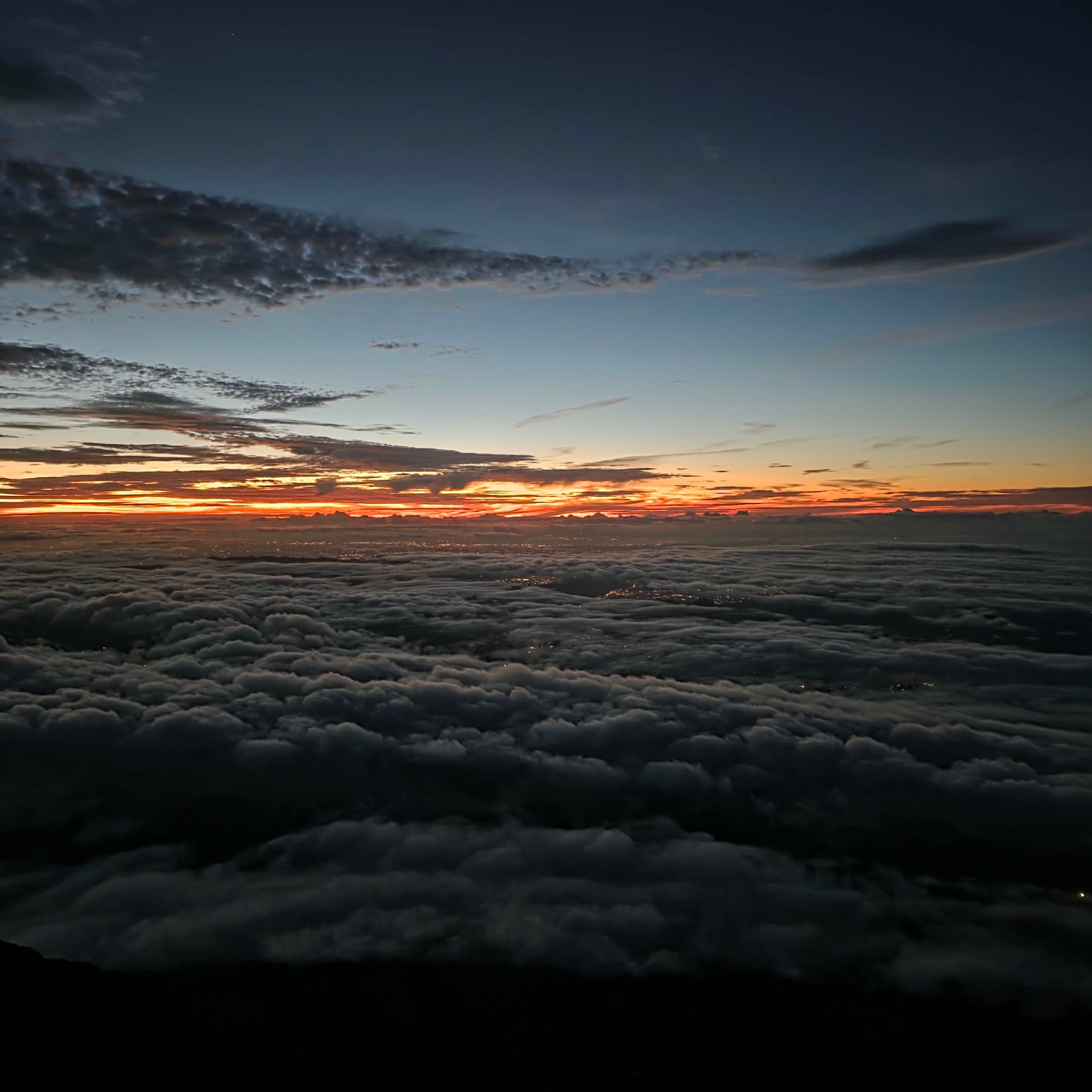 Sunrise over a sea of clouds from Mount Fuji.
