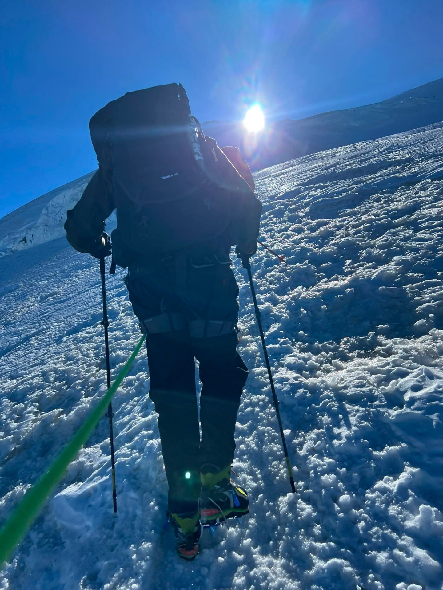 Danny Tolhurst climbing a hard snow slope in crampons.